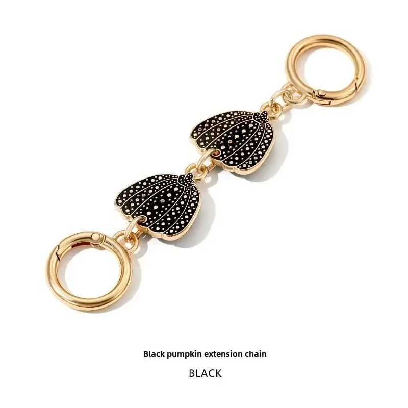 Heart-Shaped Gold Earrings with Black Polka Dot Design - Image 2