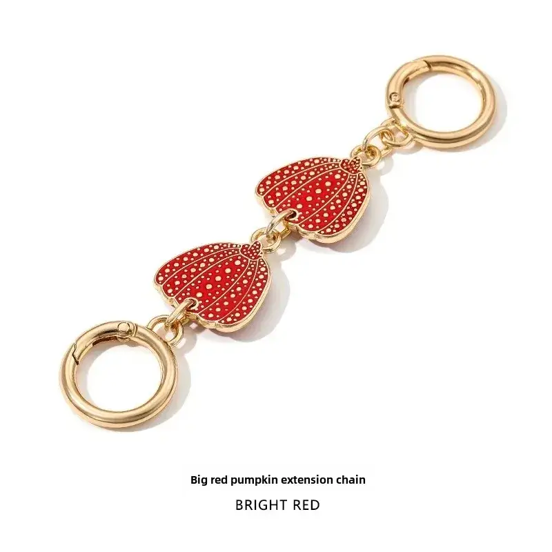 Heart-Shaped Gold Earrings with Black Polka Dot Design - Image 4