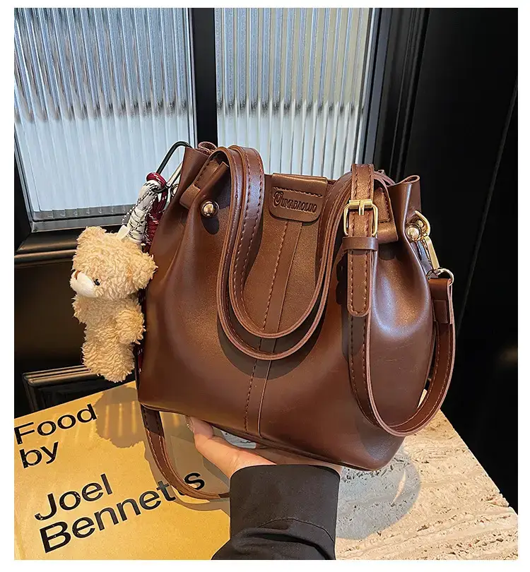 Women's Brown Leather Shoulder Bag with Pom Pom Charm — feature 1