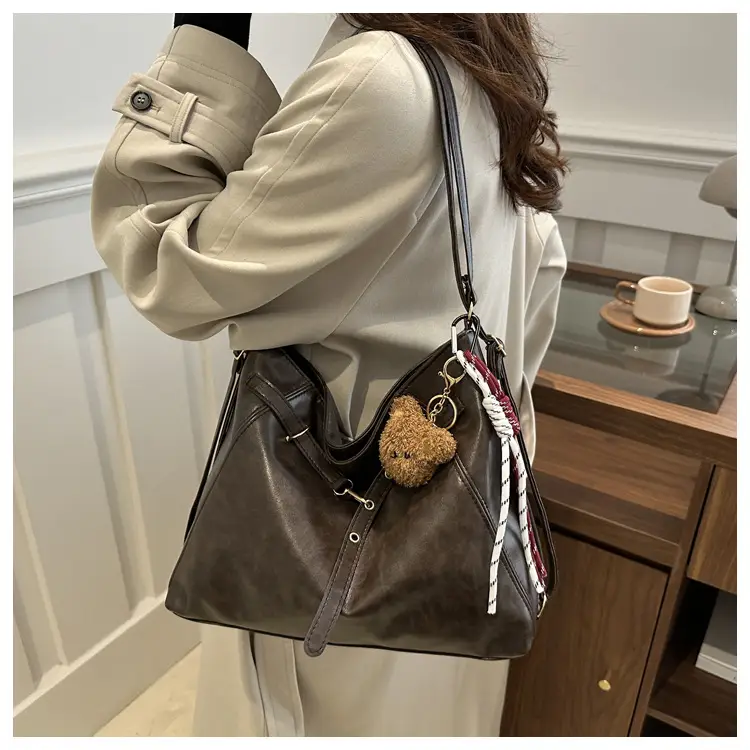 Brown Leather Shoulder Bag with Tassel Decor — feature 17