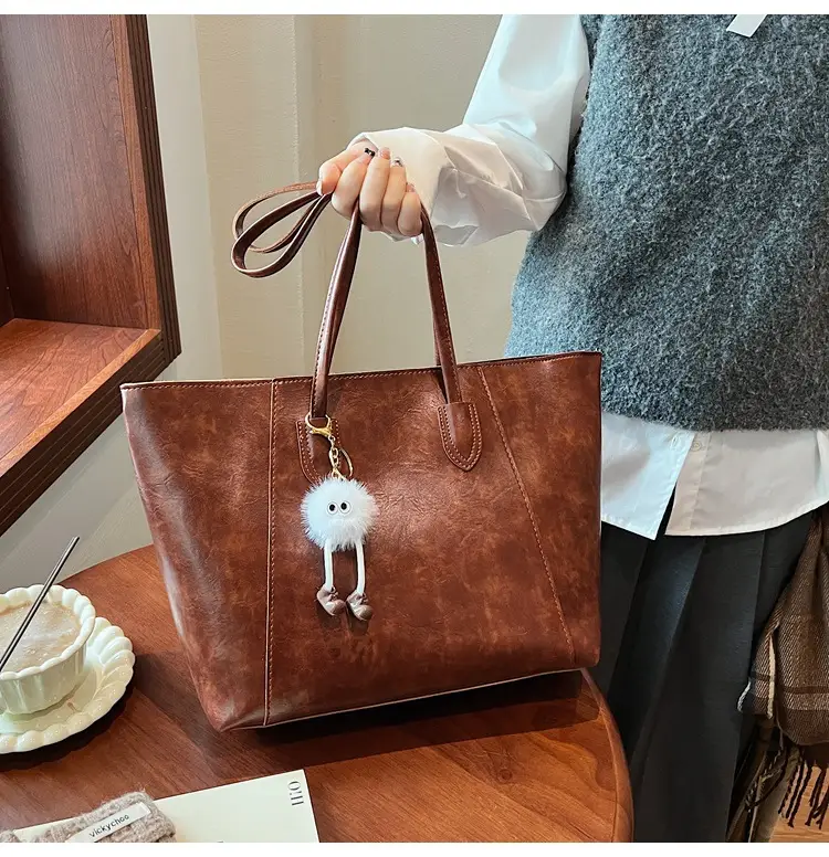 Retro Brown Leather Shoulder Bag with Pom Pom Charm — feature 21
