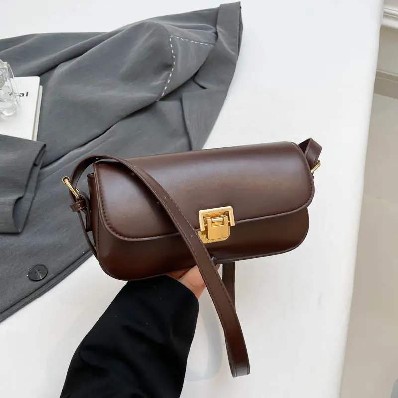 Women's Black Saddle Crossbody Bag with Gold Clasp - Image 3