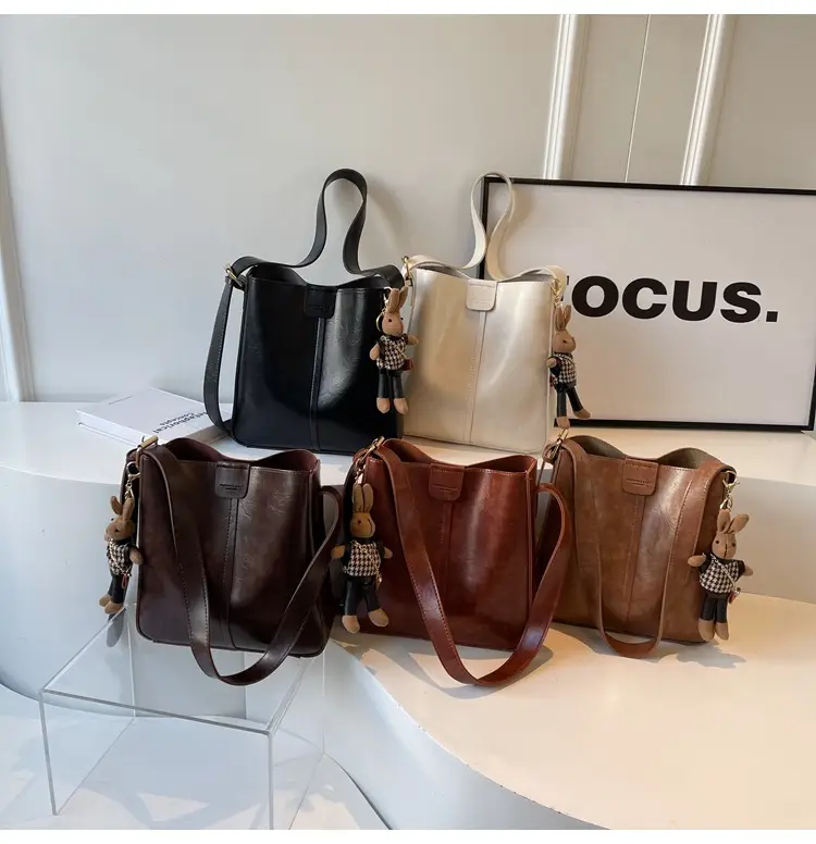 Women's Brown Leather Shoulder Bag with Cute Toy Charm — feature 1