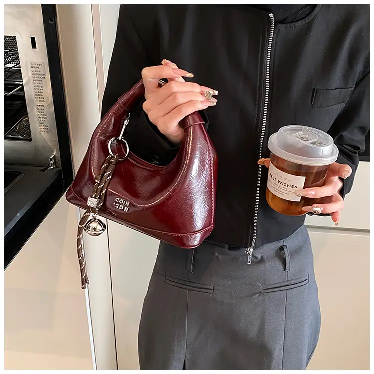 Black Leather Pea Bag with Gold Handle for Women — feature 30