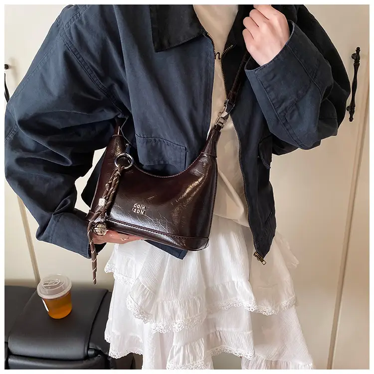 Black Leather Pea Bag with Gold Handle for Women — feature 34