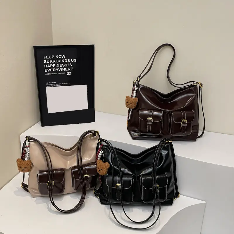 Black Leather Crossbody Bag with Gold Clasp & Teddy Keychain — feature 1