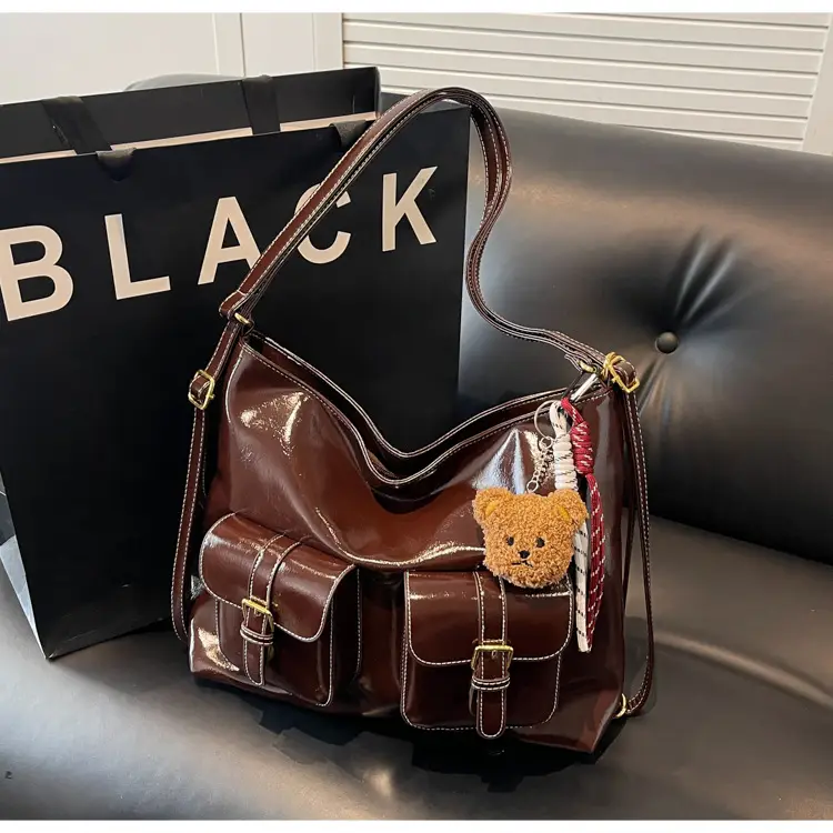 Black Leather Crossbody Bag with Gold Clasp & Teddy Keychain — feature 13