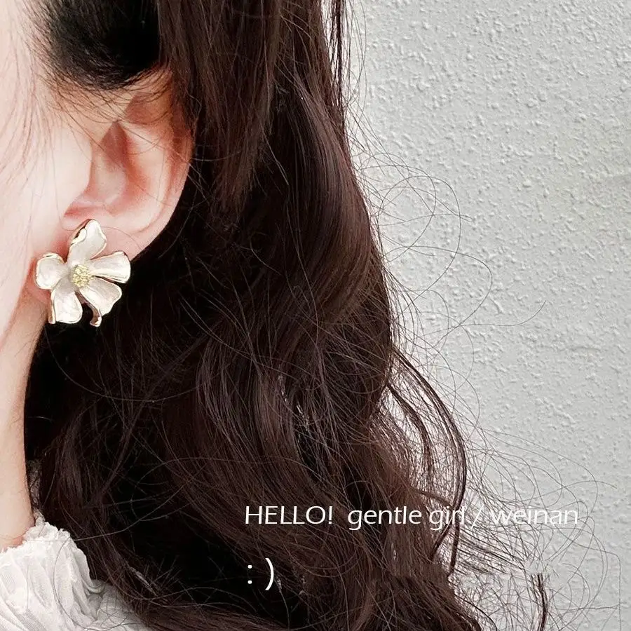 Milk White Floral Stud Earrings with Glaze Finish — feature 1