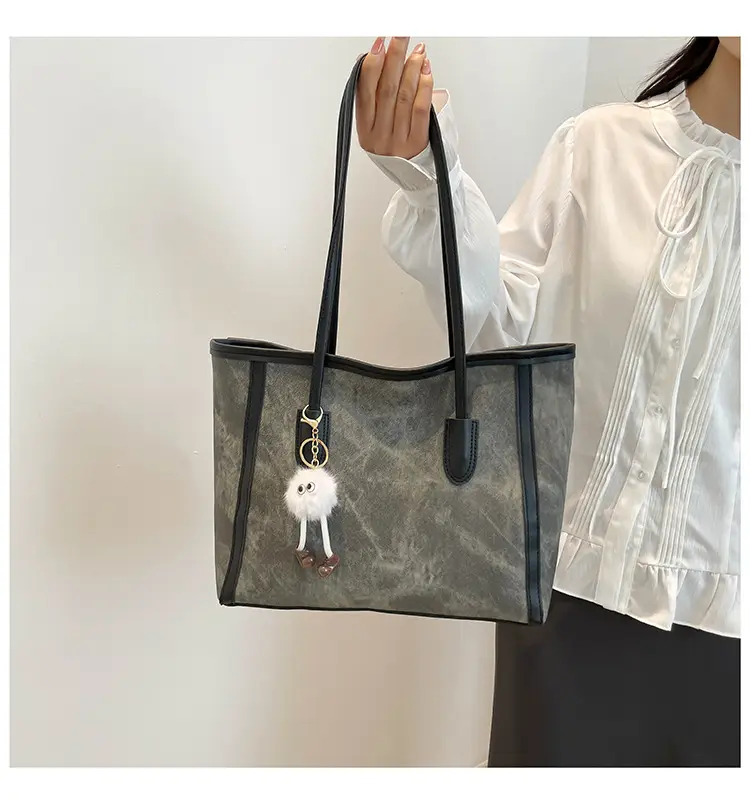 Blue Denim Underarm Bag with Pom Pom Charm — feature 24