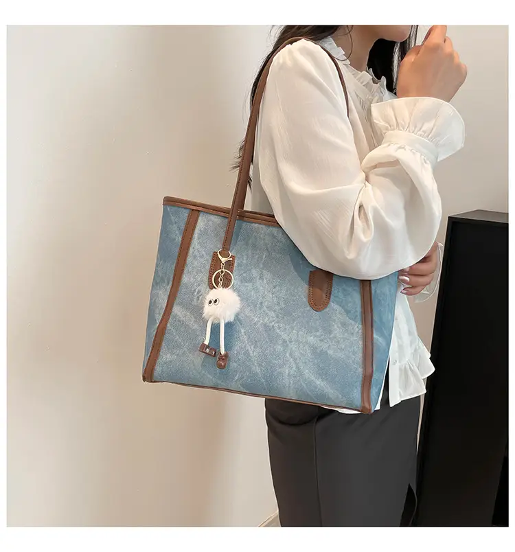 Blue Denim Underarm Bag with Pom Pom Charm — feature 26
