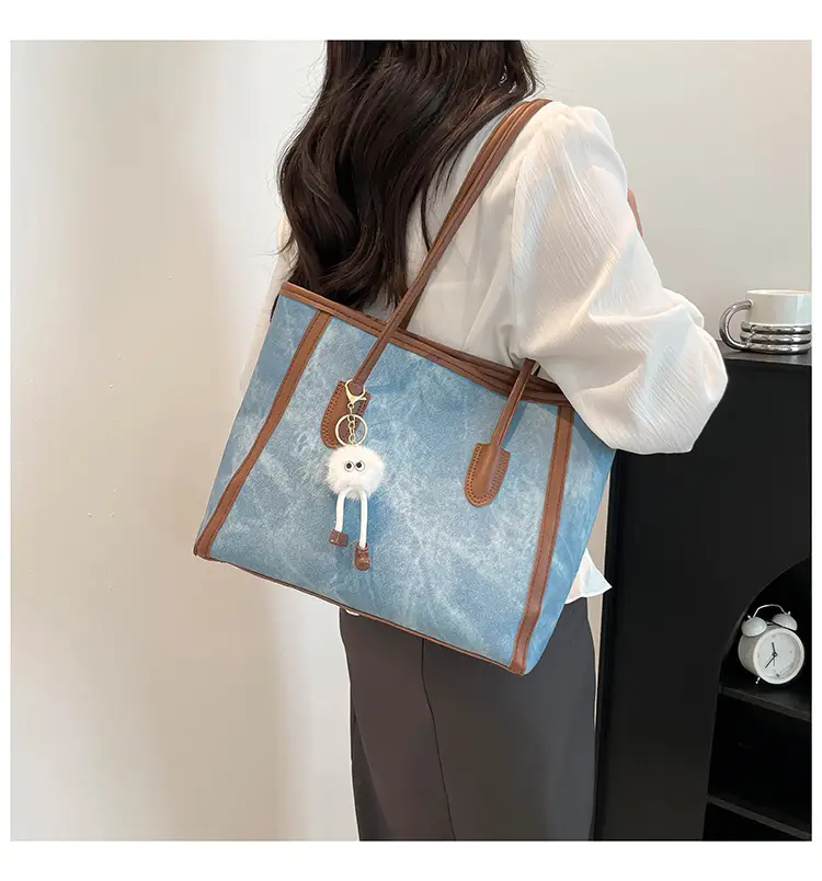Blue Denim Underarm Bag with Pom Pom Charm — feature 27