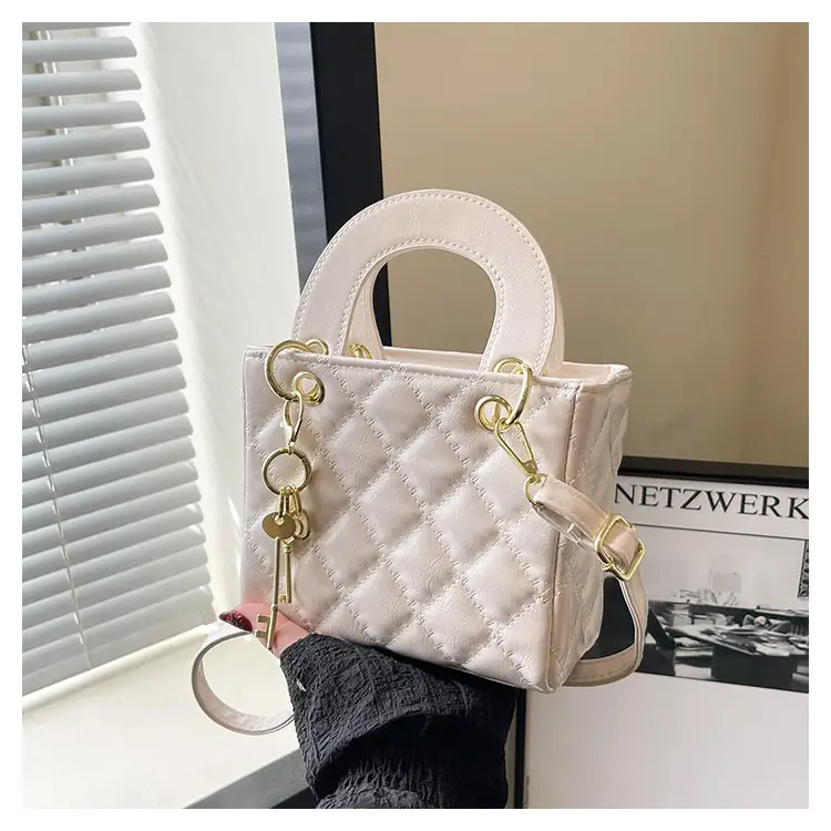 White Quilted Handbag with Gold Chain & Bow — feature 23