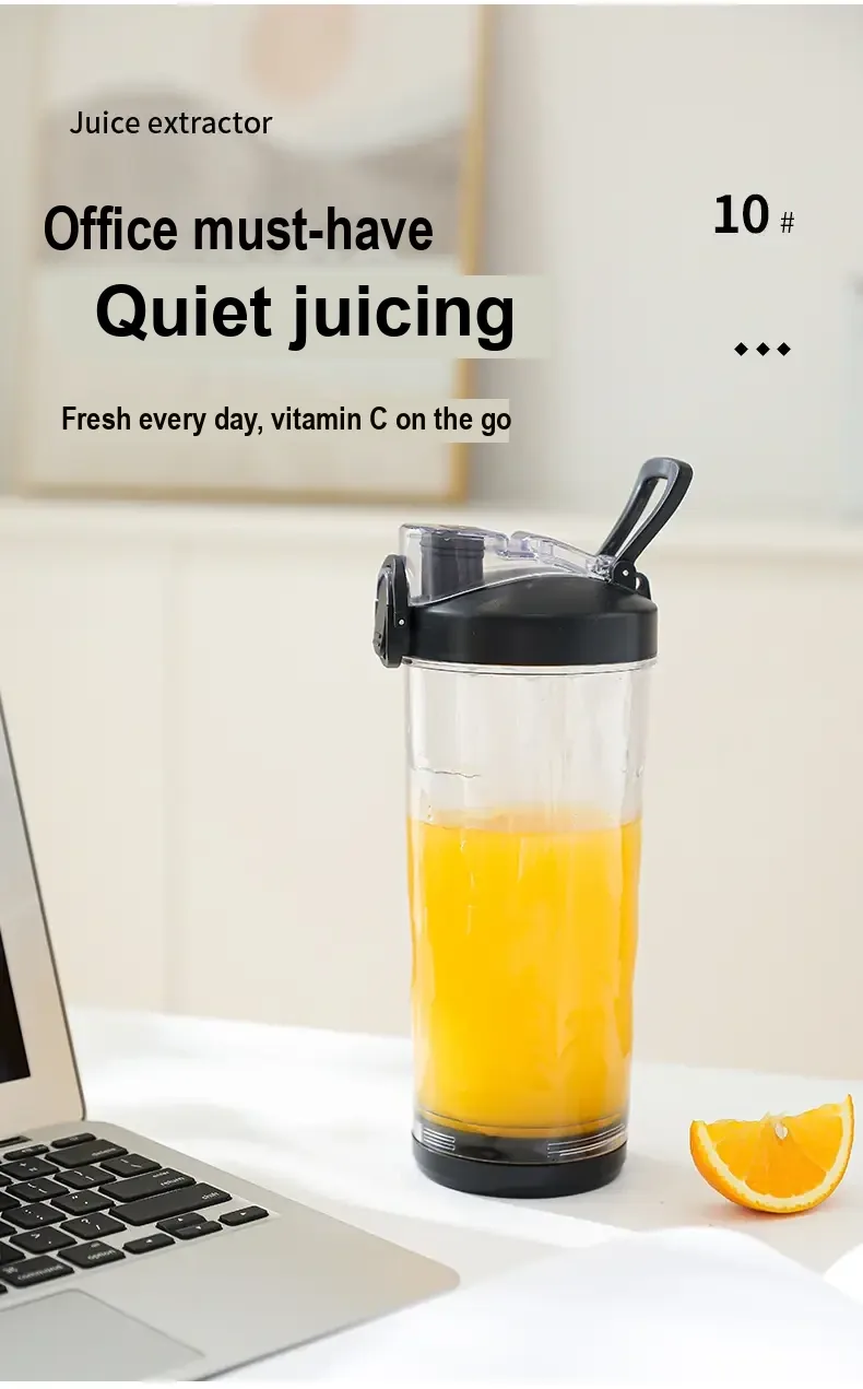 Black-lidded juicer cup containing orange juice beside a laptop.