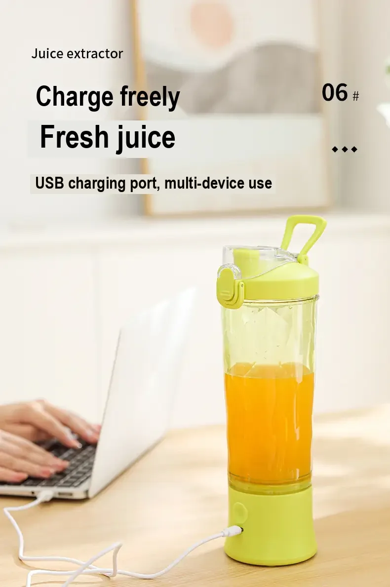 Lime juicer cup connected by cable to a laptop for charging.