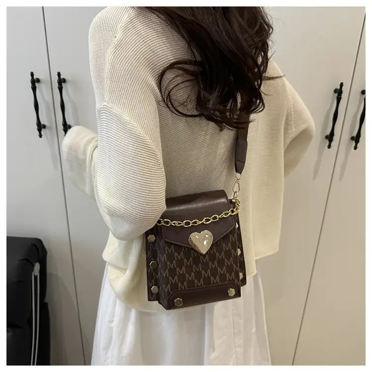 Women's tan chain strap shoulder bag with monogram pattern — feature 10