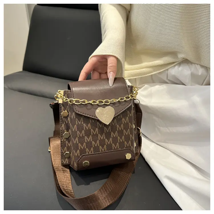 Women's tan chain strap shoulder bag with monogram pattern — feature 12