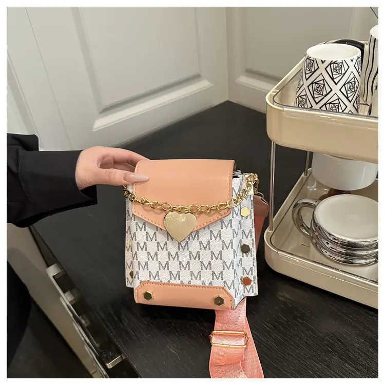 Women's tan chain strap shoulder bag with monogram pattern — feature 18