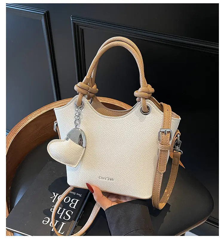 Women's Textured Crossbody Bag with Heart Charm — feature 2