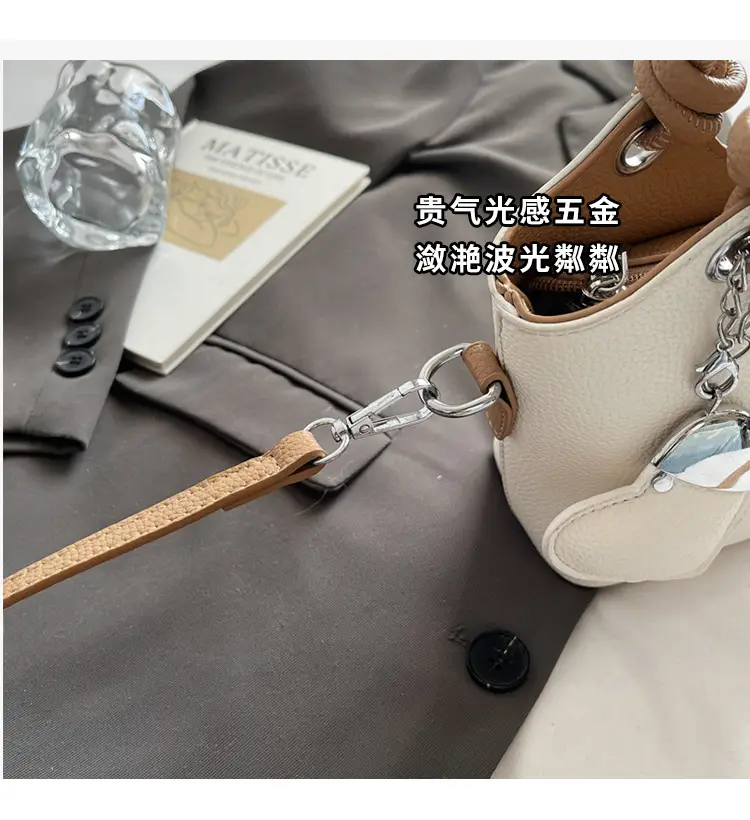 Women's Textured Crossbody Bag with Heart Charm — feature 5