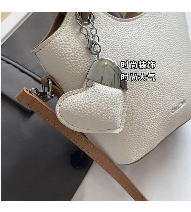 Women's Textured Crossbody Bag with Heart Charm — feature 9