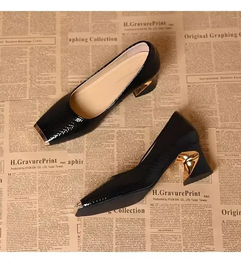 Black pumps shown from above and the side, highlighting the textured upper and metallic heel detail.
