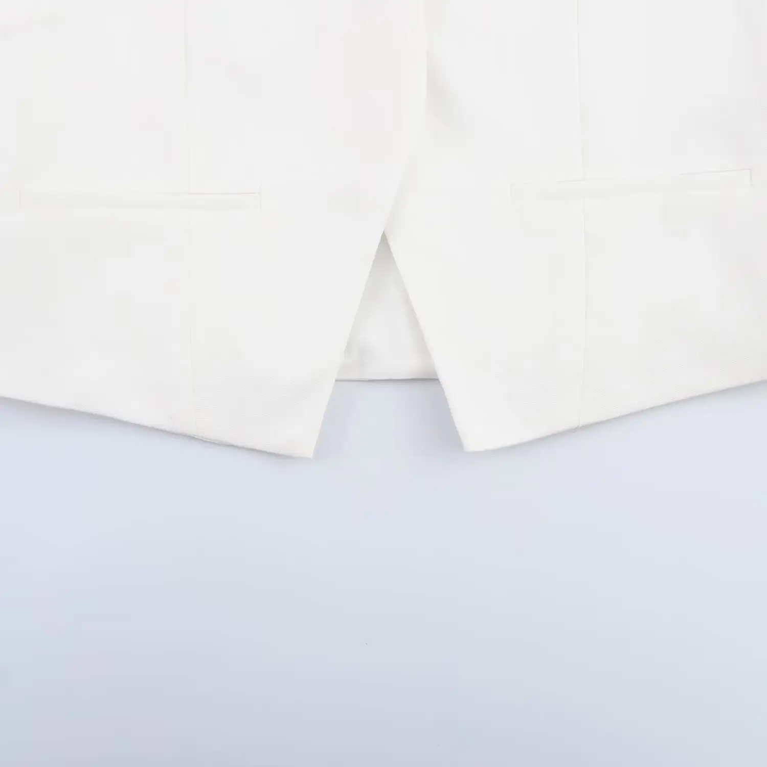 White Sleeveless Vest with Belted Pleated Pants — feature 7