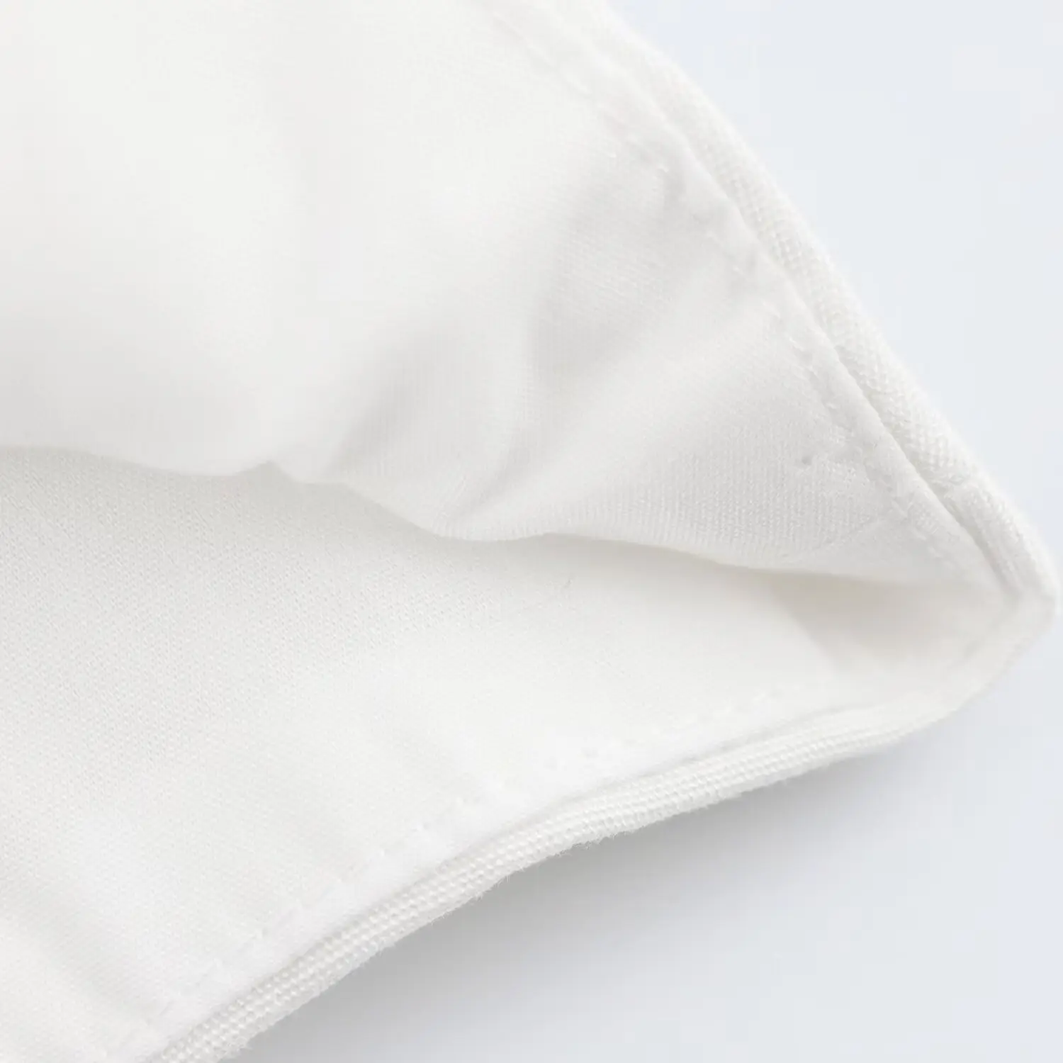 White Sleeveless Vest with Belted Pleated Pants — feature 9