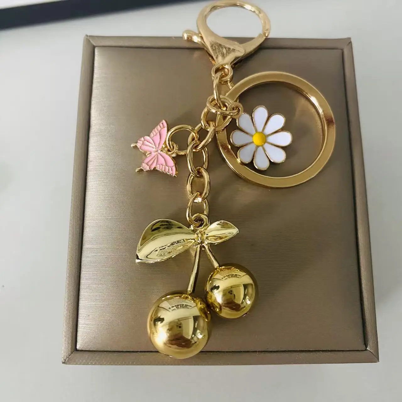 Gold Flower Pendant with Cherry & Butterfly Design — feature 2