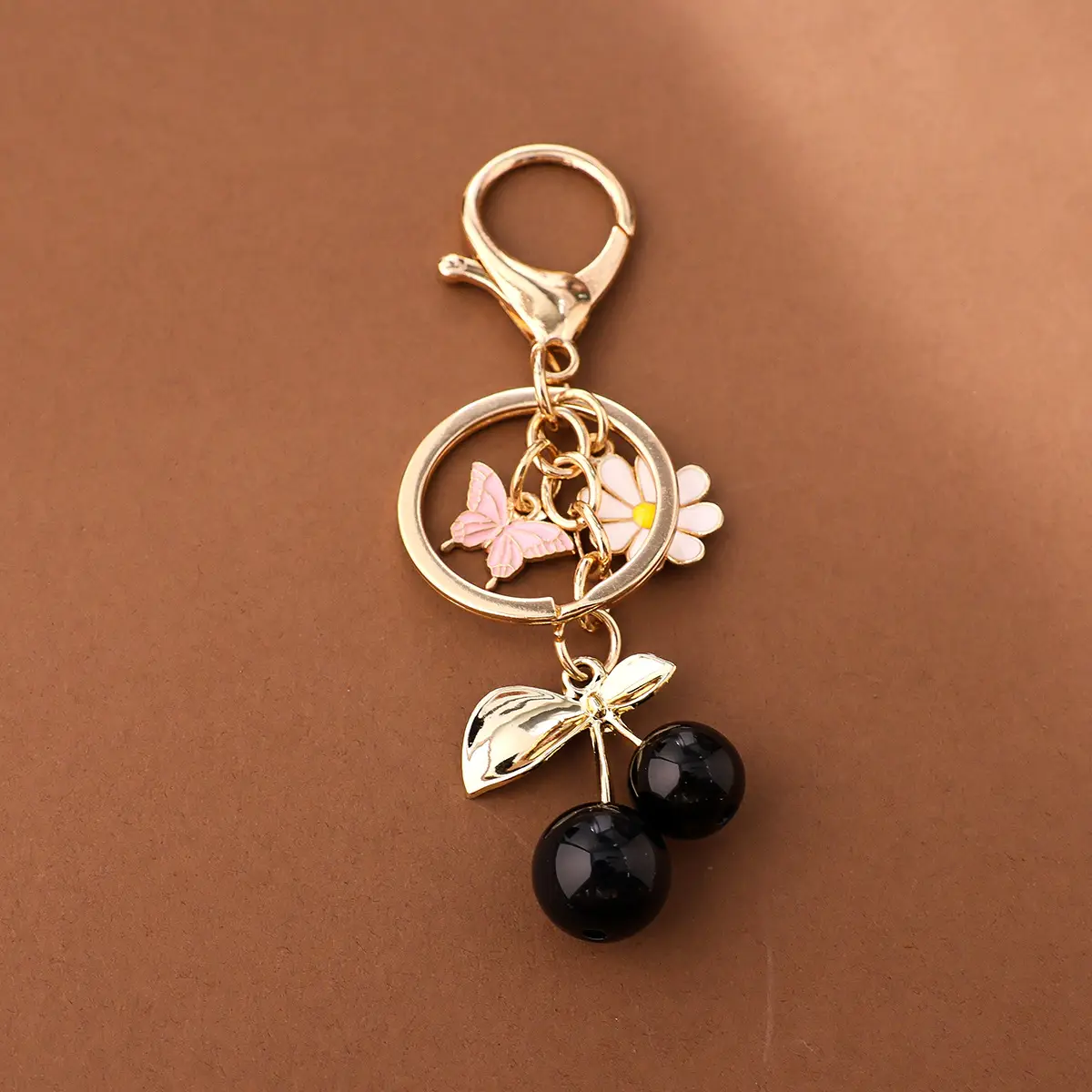 Gold Flower Pendant with Cherry & Butterfly Design — feature 6