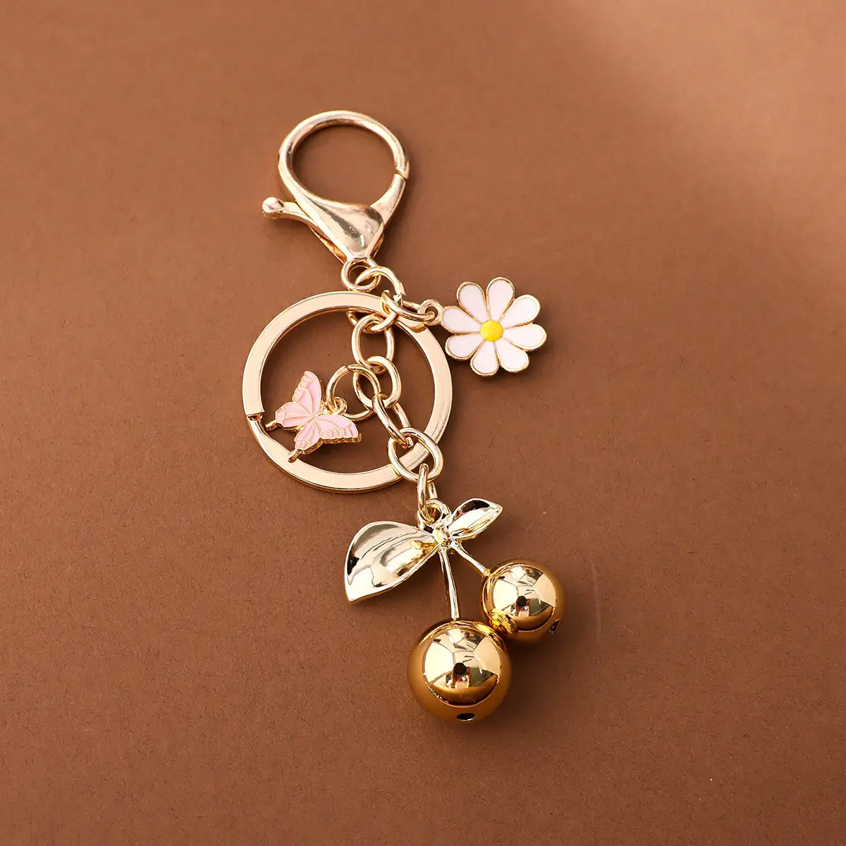 Gold Flower Pendant with Cherry & Butterfly Design — feature 9