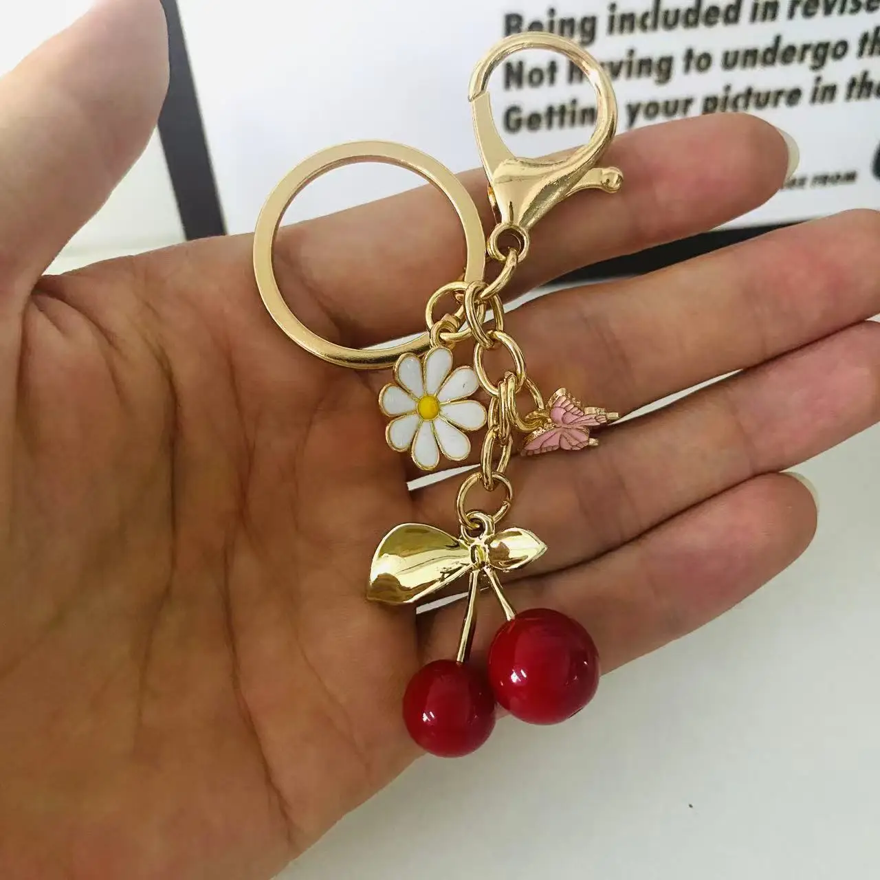 Gold Flower Pendant with Cherry & Butterfly Design - Image 10
