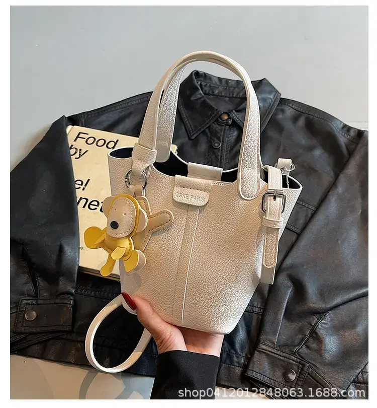 Beige Lychee Bucket Bag with Charm & Strap — feature 1