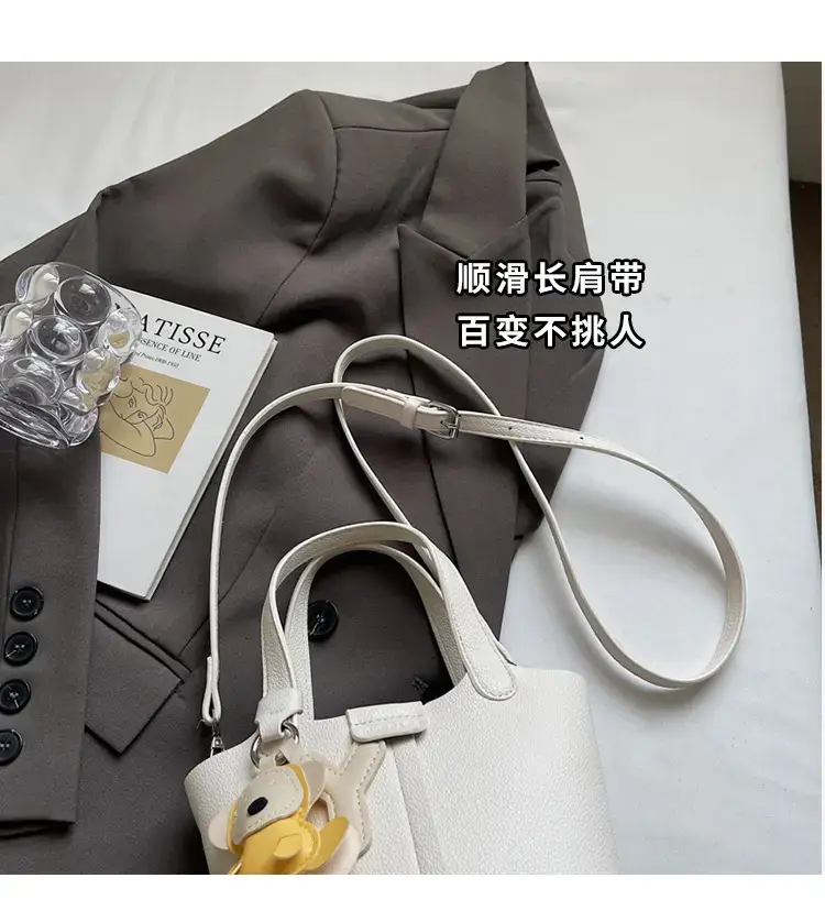 Beige Lychee Bucket Bag with Charm & Strap — feature 3