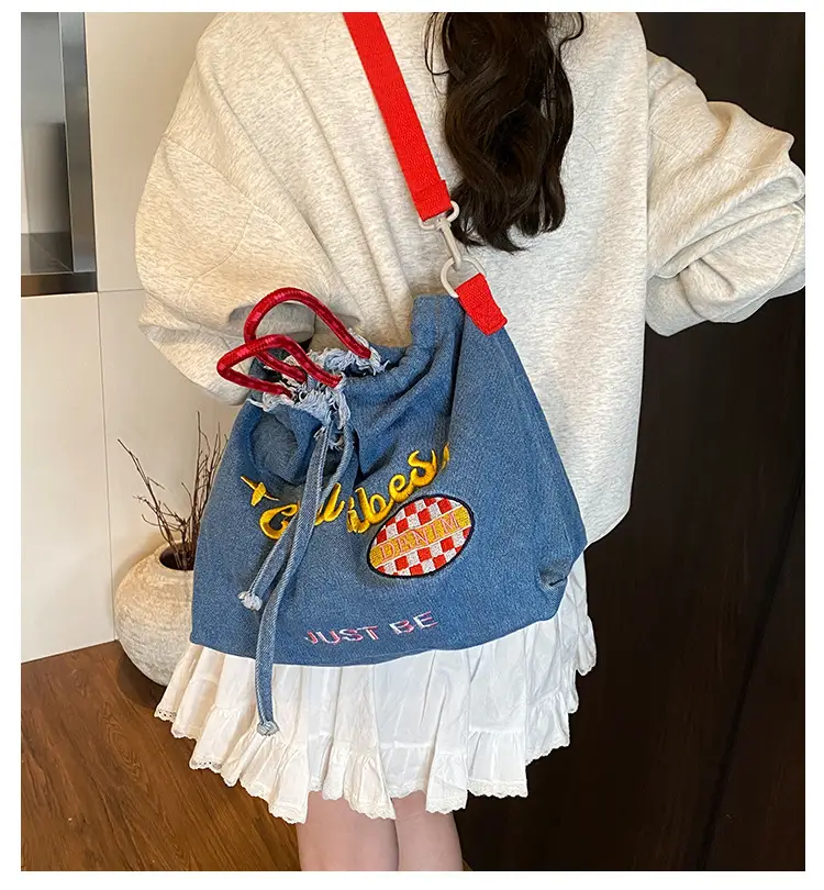 Blue Denim Shoulder Bag with "T Girl Robber" Design — feature 1