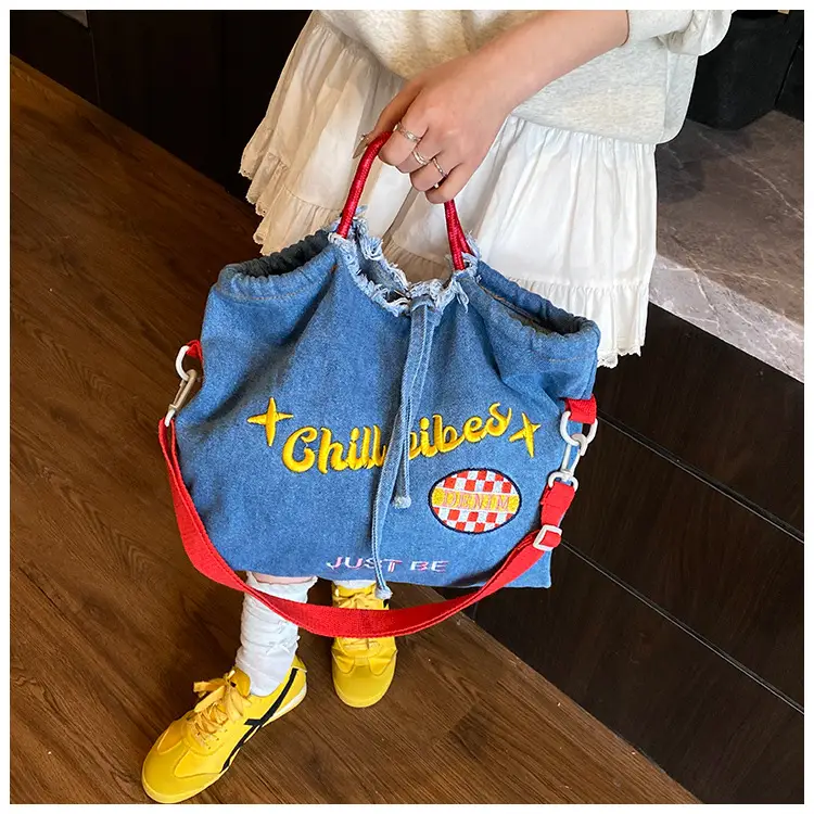 Blue Denim Shoulder Bag with "T Girl Robber" Design — feature 13