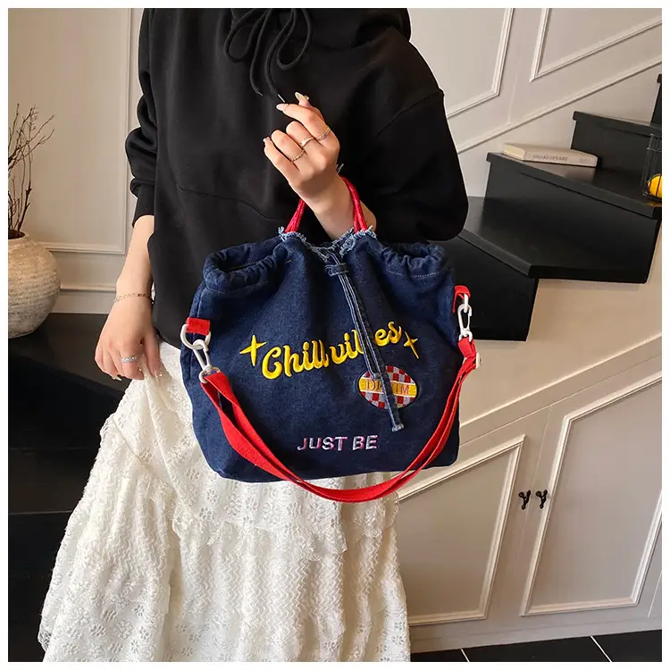 Blue Denim Shoulder Bag with "T Girl Robber" Design — feature 19