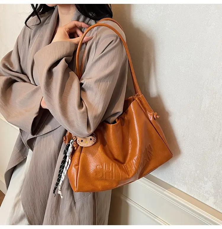 Stylish Brown Crossbody Bag with Cute Charm — feature 3