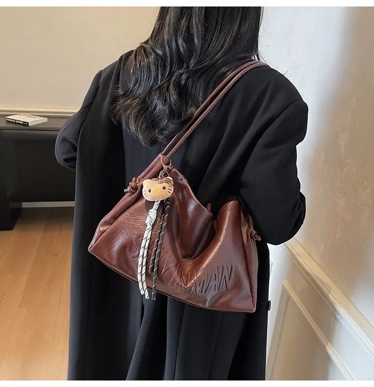 Stylish Brown Crossbody Bag with Cute Charm — feature 4