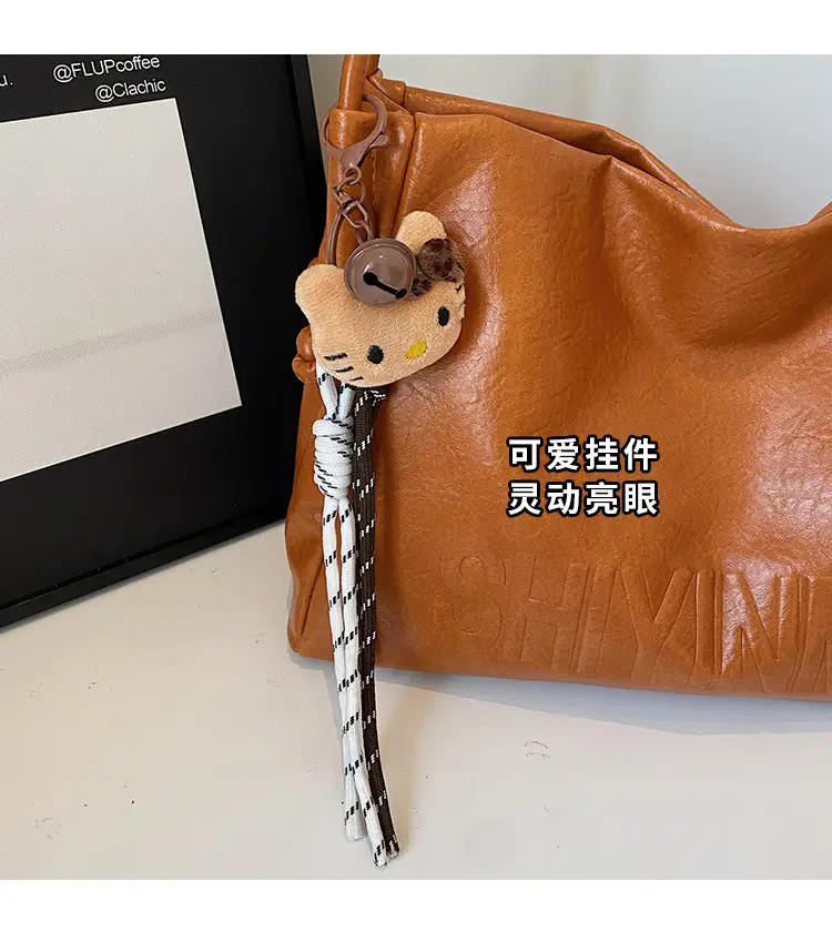 Stylish Brown Crossbody Bag with Cute Charm — feature 8