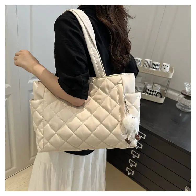 Black Quilted Women's Shoulder Bag with Pom Pom Charm — feature 13