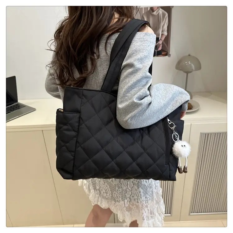 Black Quilted Women's Shoulder Bag with Pom Pom Charm — feature 23