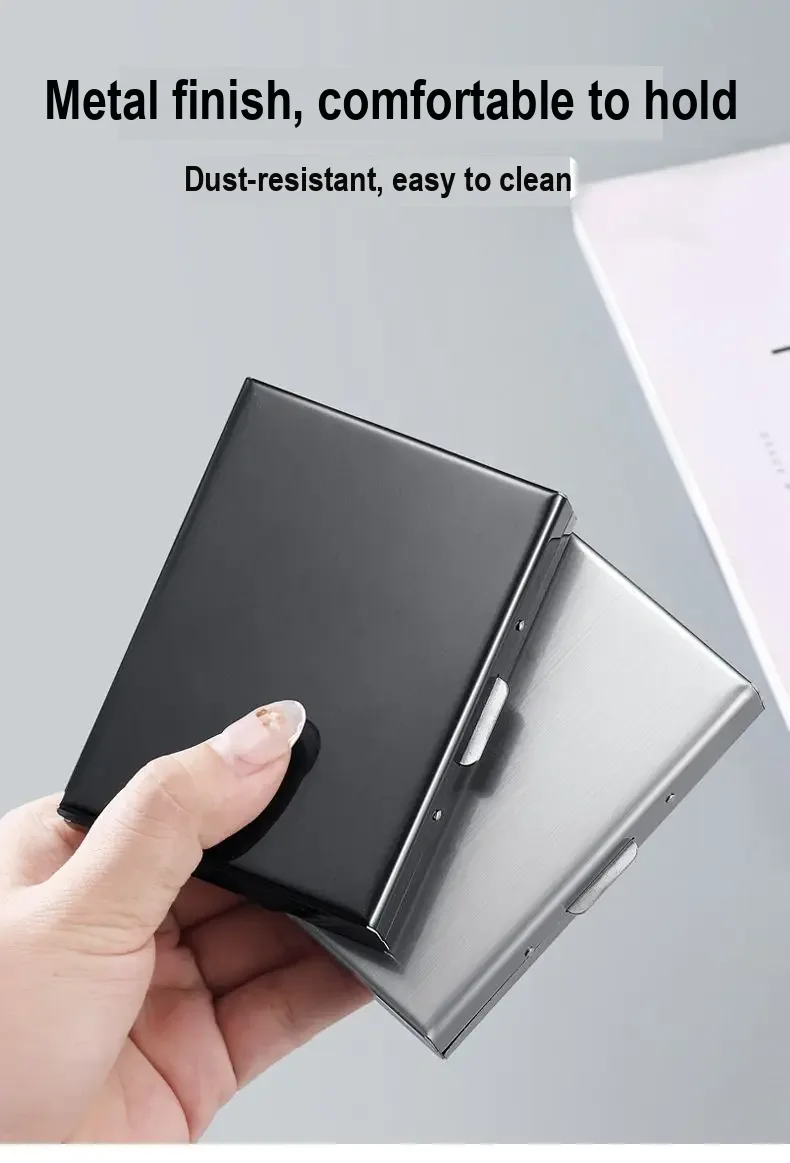 Black and silver card holders held in a hand