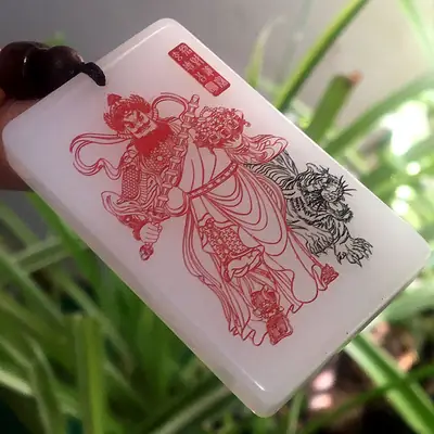 White Jade Xuantian Carved Pendant with Red & Black Design