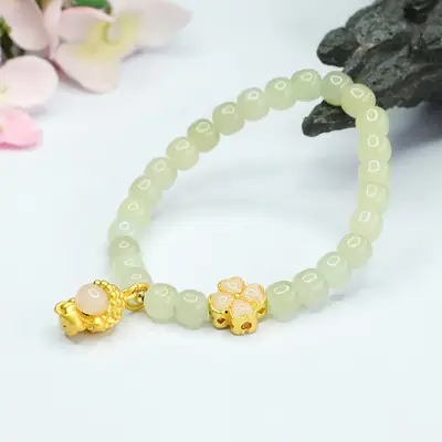 Glowing Green Jade Buddha Bracelet with Four Leaf Clover