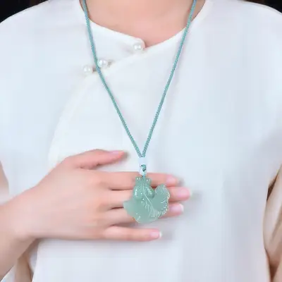 Green Jade Leaf Pendant with Goldfish Design