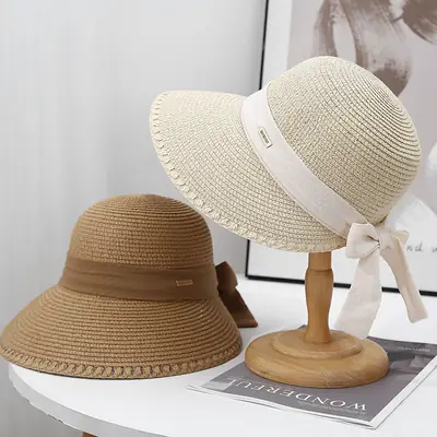 Wide-brimmed straw sunhat with lace bow for summer beach wear