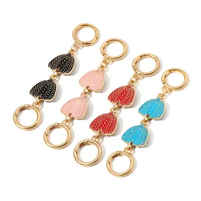 Heart-Shaped Gold Earrings with Black Polka Dot Design
