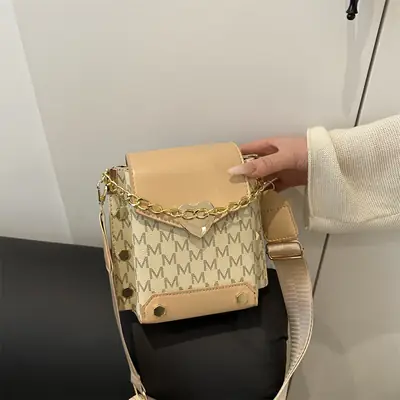 Women's tan chain strap shoulder bag with monogram pattern