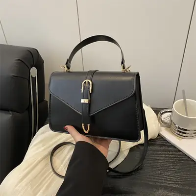 Black Leather Shoulder Bag with Gold Clasp