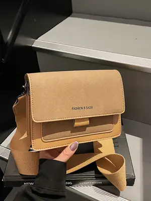 Women's tan leather crossbody bag with wide strap